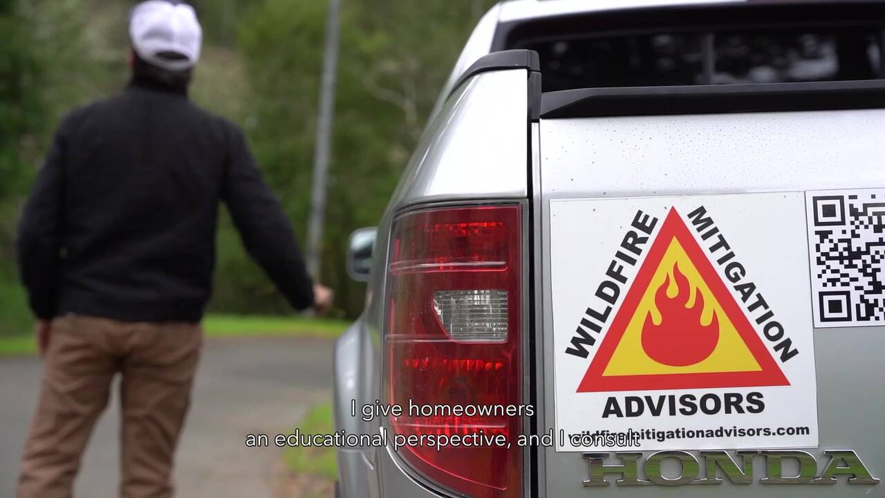 Stuart Mitchell of Wildfire Mitigation Advisors featured in the ROCKWOOL wildfire video, standing beside the WMA vehicle