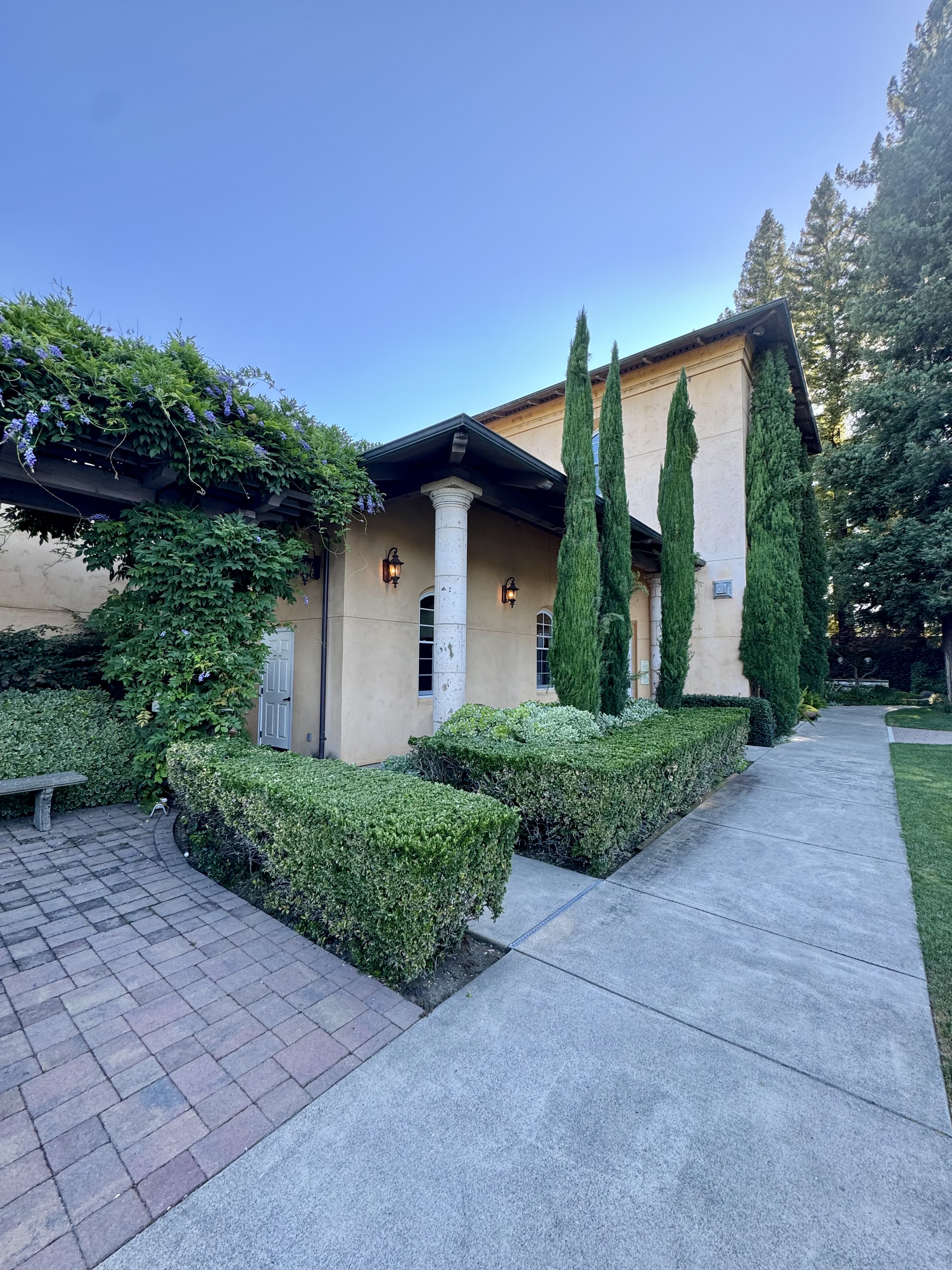 Wine country estate with Italian cypress, manicured hedges, and wisteria pergola, the type of high-value property WMA assesses